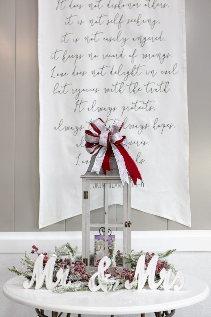 Winter wedding decor and the love chapter on a large wall hanging at Bella Rosa Venue near Tulsa OK